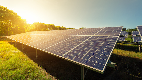 the sun rises on a photovoltaic solar panel