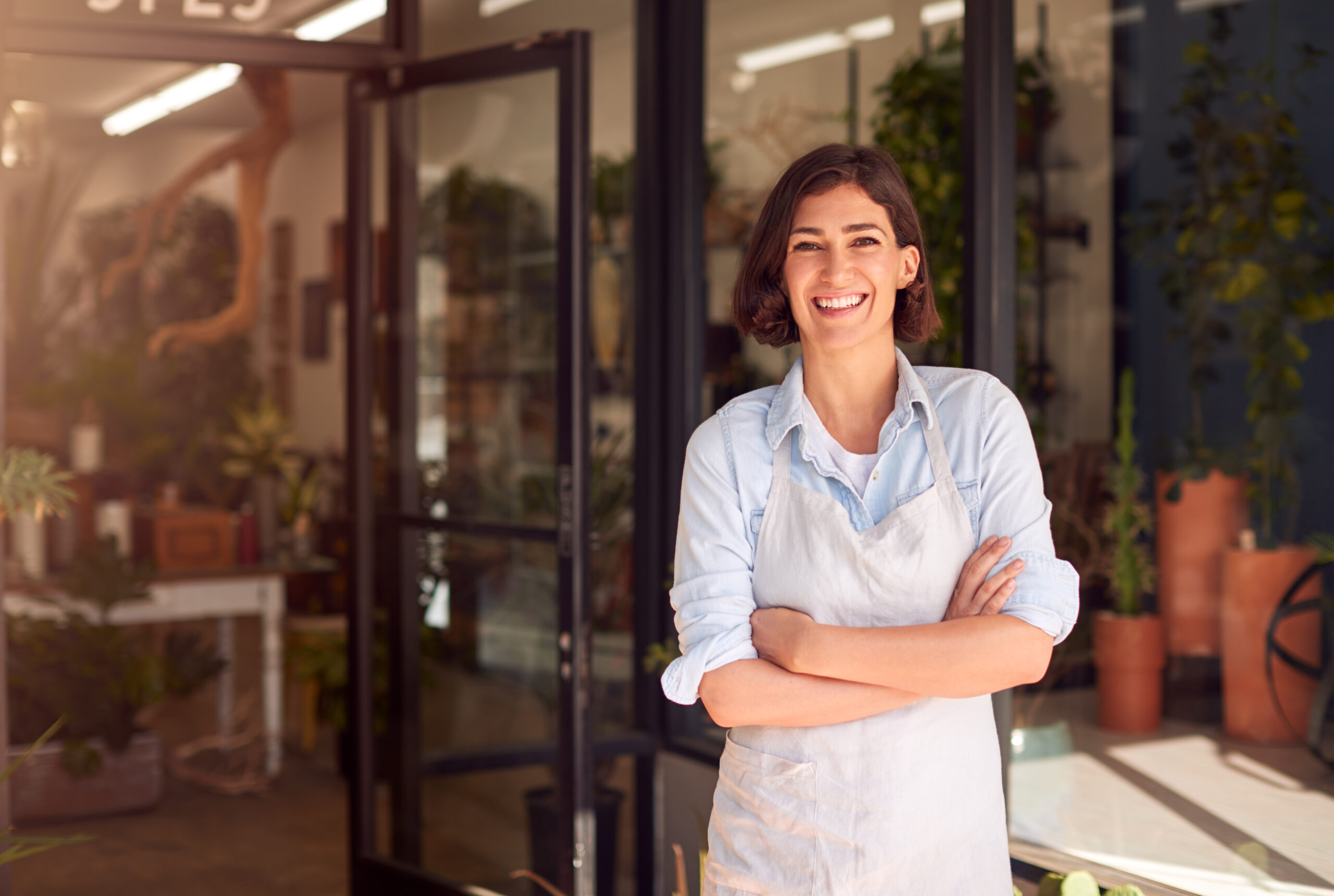 Smiling female owner florists scaled