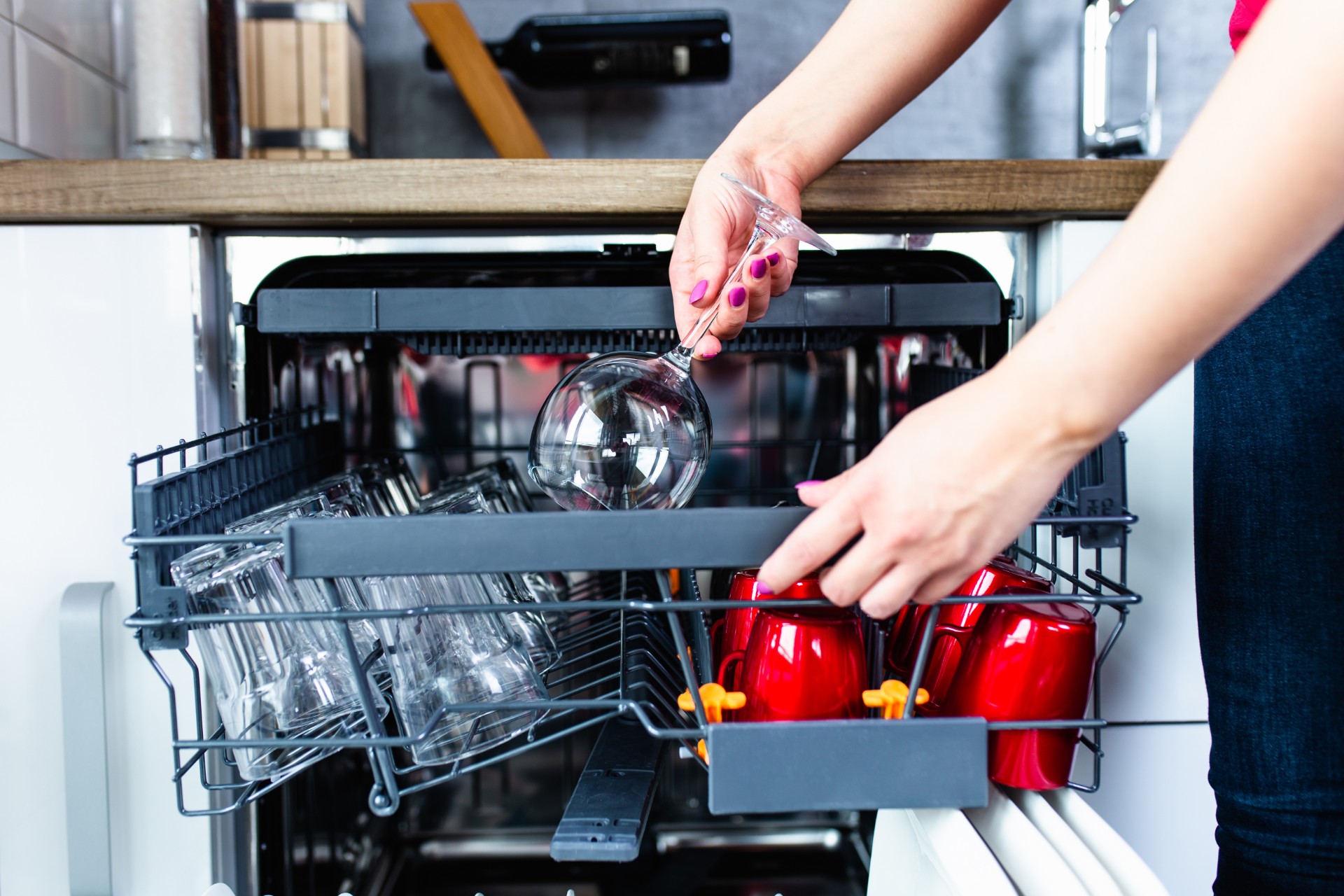Woman loading a dishwasher