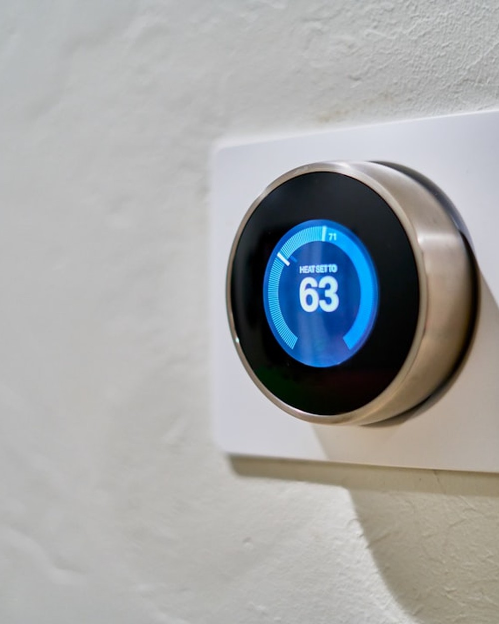 Why Are Electricity Bills Going Up On The Ercot And Pjm Grids? 3 Smart thermostat mounted on a wall showing energy efficient home temperature control