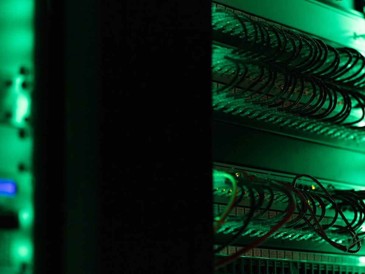 Why Are Electricity Bills Going Up On The Ercot And Pjm Grids? 1 Data center server racks illuminated in a dark facility representing ai and hyperscale power demand
