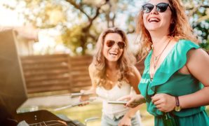 Two girlfriends having a good time and barbequing