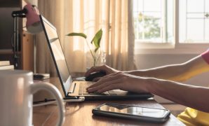 Someone working from home typing on their computer